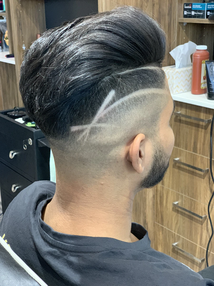 Men's fade haircut by the barber at Salon Kreed in Colorado Springs